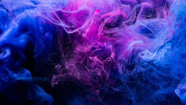 Photo color explosion fluorescent background paint in water vibrant smoke cloud texture glowing neon blue