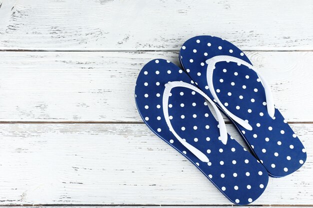 Color flipflops on wooden background