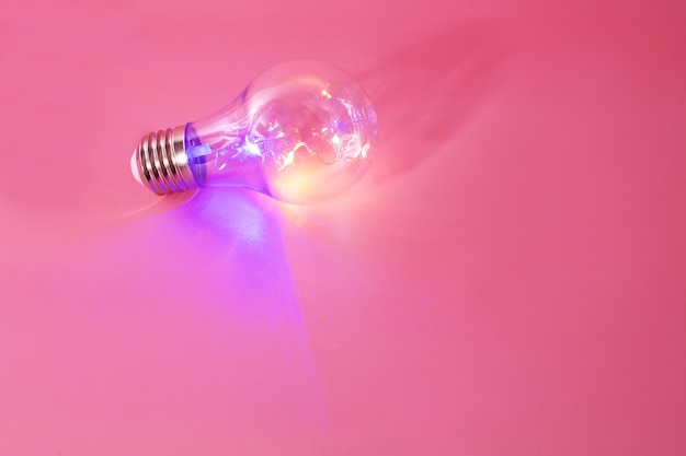 Color light bulb on pink background