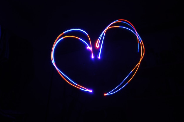 Color Light Lamp move Heart shape on long exposure shot in the dark.