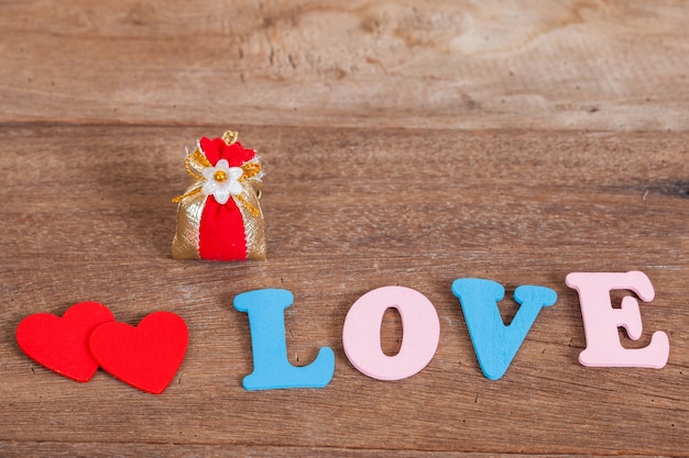 color love letters on wood with flower basket