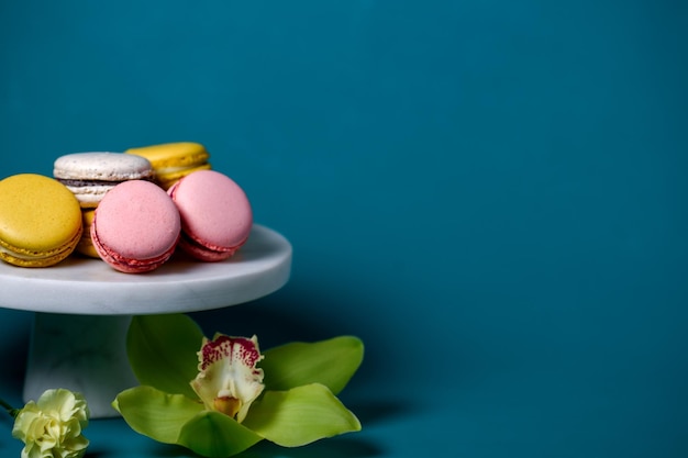 Color macarons macaroons on white marbel cake stand.