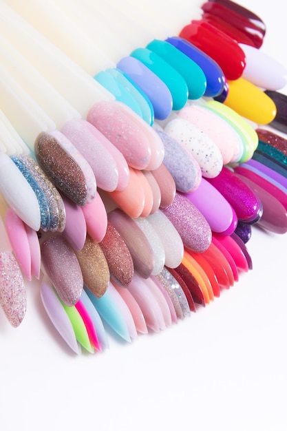 Color palette with nail gel polishes for manicure on a white background Vertical format