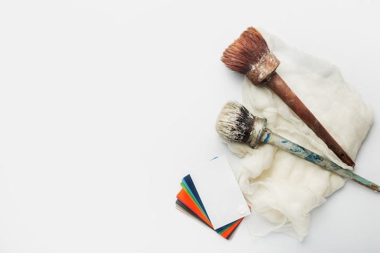 Photo color palette with shades of paint and paint brushes on a white