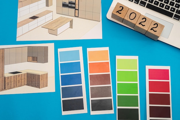 Color palettes and new designs of sketches of apartments are laid out in an axis on the table