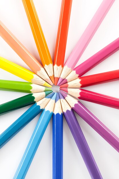 Color pencils in arrange in color wheel colors on white space