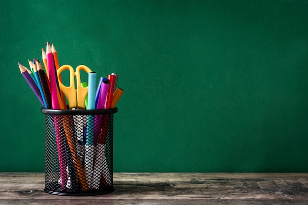 Color pencils on wooden table and gre