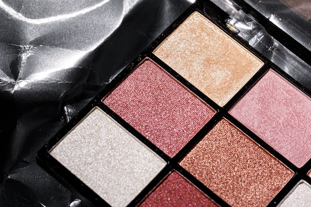 Color professional cosmetic palette on a dark background, close up