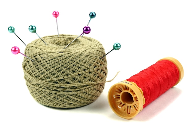 Color sewing pins with threads coil on white