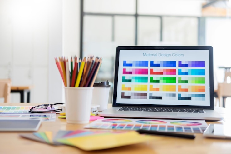 Photo color swatches on laptop screen at office table