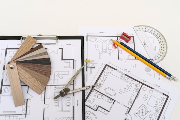 Color swatches palette with pencil on house layout blueprint at office desk Creative project workplace
