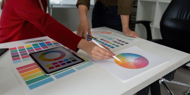 Color Theory and Teamwork Designers discussing color theory while working on digital and printed palettes