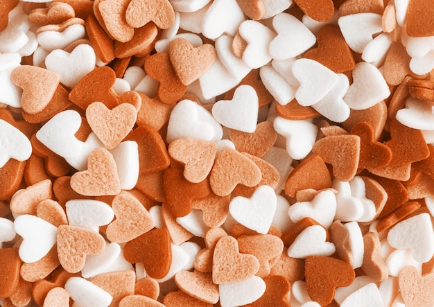 Color of the year 2024 Peach Fuzz heart shapes sprinkles background