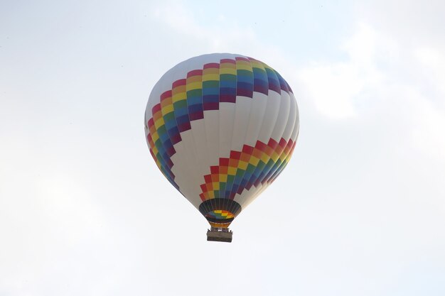 Colored balloon with people flying in the sky in Cappadocia
