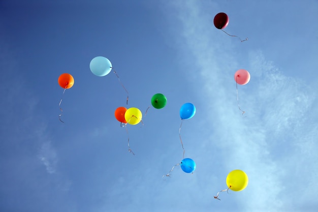 colored balloons flying in the blue sky