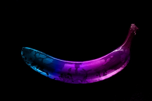 colored banana on black background neon modern style pop art