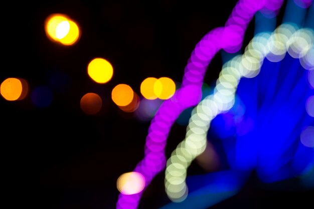 Colored blurred bokeh. abstract background of included festive garlands. colorful blur light bulbs