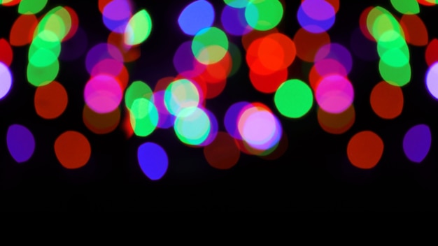 Colored bokeh on a black background. colorful bokeh background