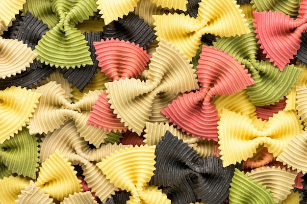 Colored bow tie pasta. Closeup multiple farfalle.