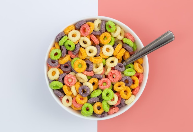 Colored breakfast cereal in a bowl on a colored background flat lay children039s healthy breakfast
