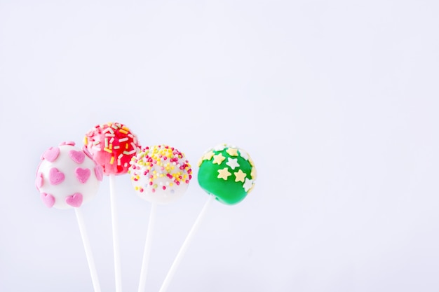 colored cake pops on isolated white background