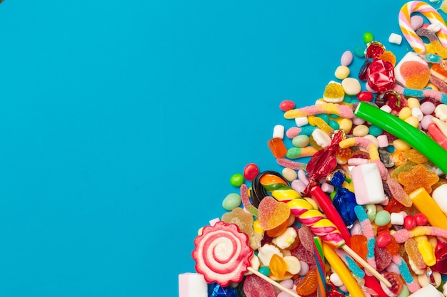 Colored candies on blue background