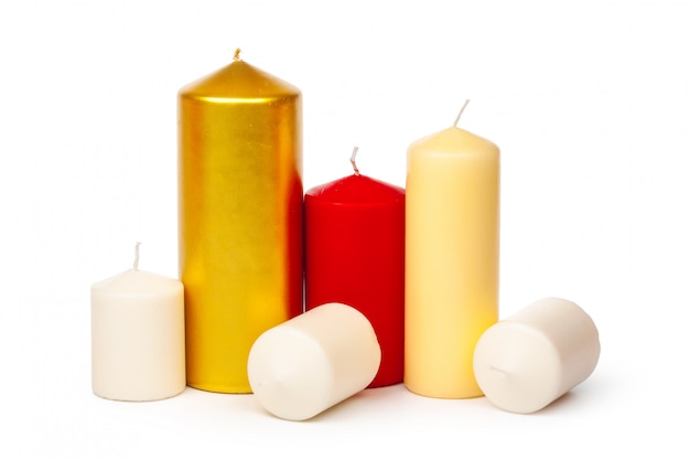 Colored candles of different size on white 