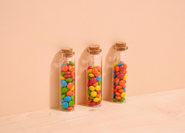 Photo colored candy lies in glass jars sweets and fun mood