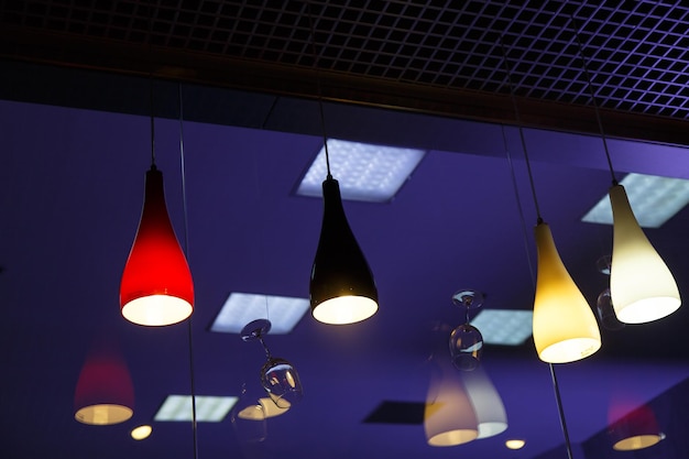 Photo colored chandeliers hang in the dark office can be used to illu