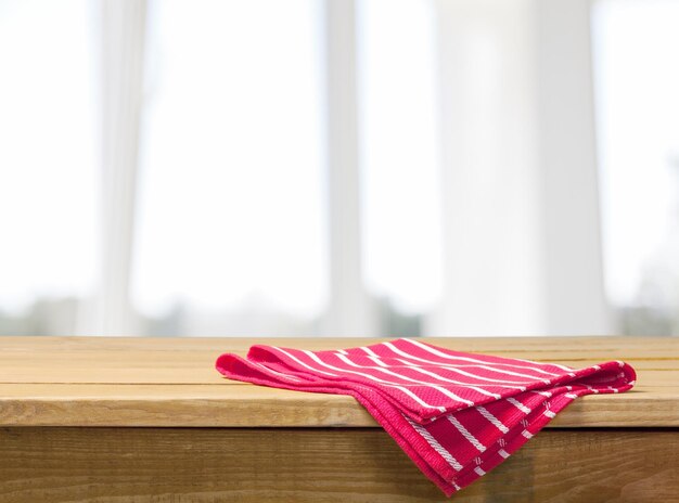 Colored checked tablecloth on wooden table