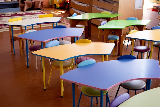 Colored children's tables in the kindergarten close-up.