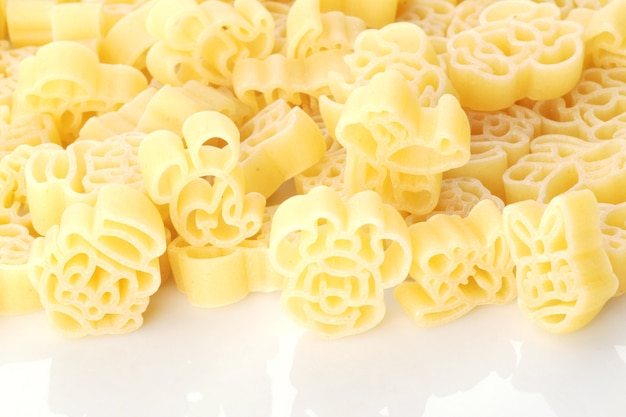 colored childrens pasta of different shapes on a white background large