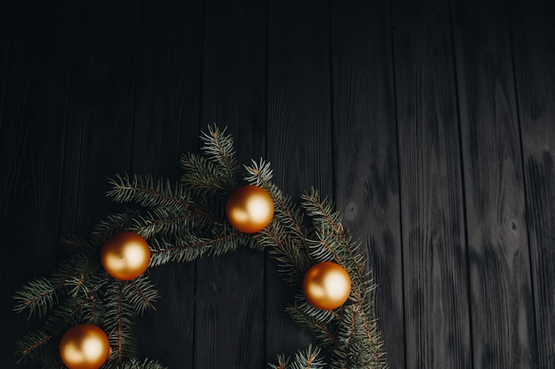 Colored christmas decorations on black wooden table. Xmas balls on wooden background.