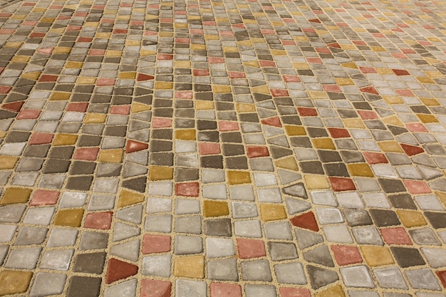 Colored cobblestones pavement at the city. Closeup shot