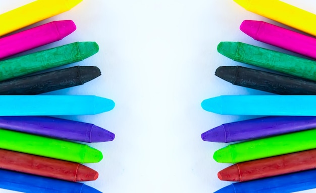 Colored crayons on paper background