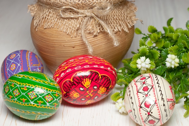 Colored Easter eggs and vintage clay pot