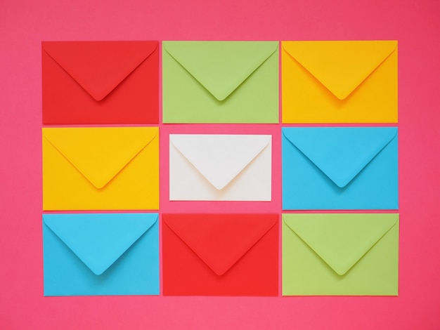 Colored envelopes on pink background