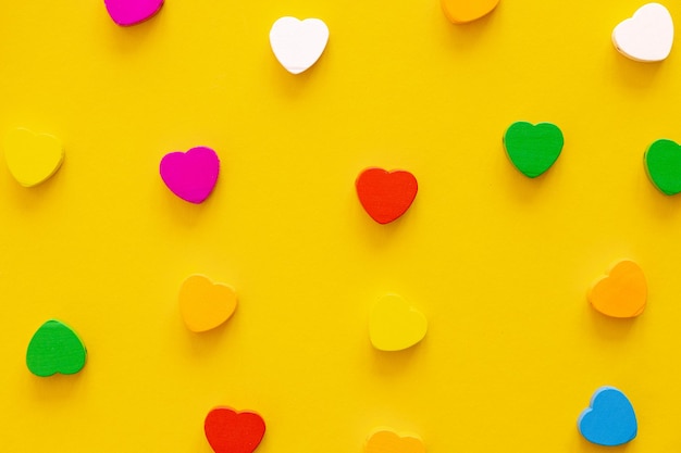 Colored figures in the form of heart on a yellow background