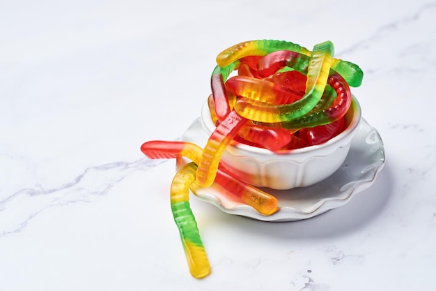 Colored gummy worms in a bowl