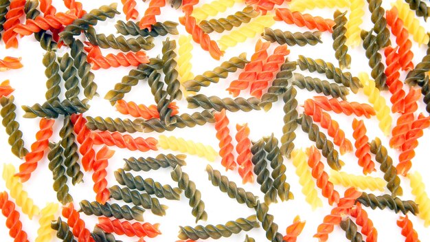 Colored italian pasta on a white background. flour products and food in cooking