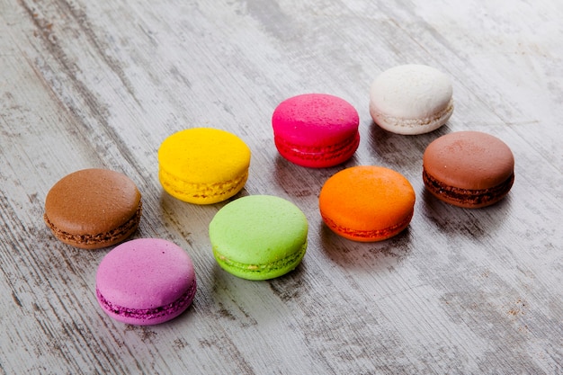 colored macaroon on wooden background