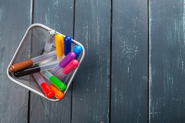 Colored marker pens on wood background