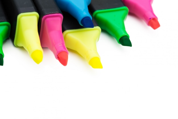 Colored markers isolated on white background close up