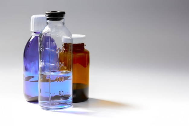 Colored medial bottles on gray background with copyspace