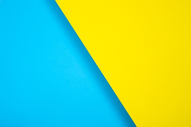 Colored paper background. bright color, blue and yellow. diagonally, with a shadow. For design, text