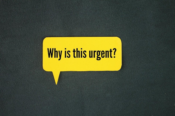 Photo colored paper with the question words why is this urgent