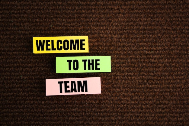 Photo colored paper with the word welcome to the team we are hiring join the group the concept of team