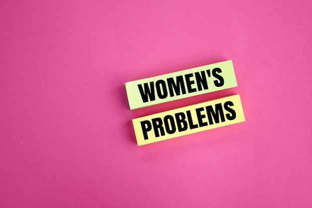 colored paper with the word women's problems the concept of female habit problems