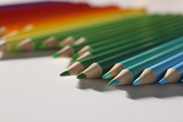 Colored pencil set loosely arranged on surface and not arranged exactly in row