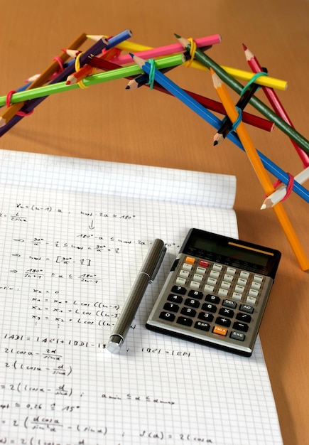 Foto struttura a matita colorata per libro e calcolatrice su tavolo